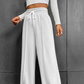 Högmidjade byxor med vida ben och dragsko för damer